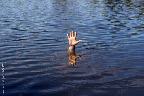 a man is drowning, his hand is sticking out of the water	 photo