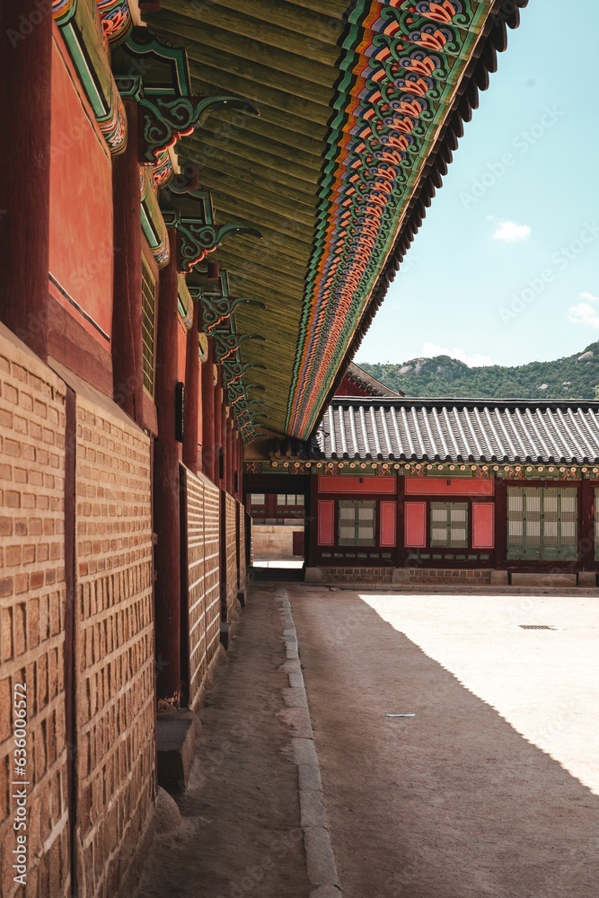 Vertical shot of a traditional Korean building under the sunlight and a blue sky