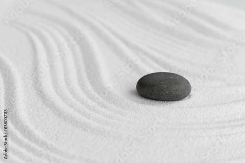 Valokuvatapetti Zen Garden with Grey Stone on White Sand Line Texture Background, Top View Black Rock Sea Stone on Sand Wave Parallel Lines Pattern in Japanese stye, Simplicity Day, Meditation,Zen like concept