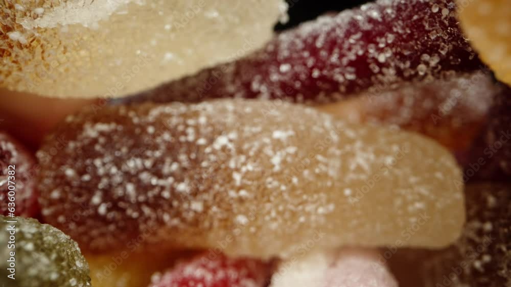 Variouscolored, shaped, and flavored gummy candies are scattered, and