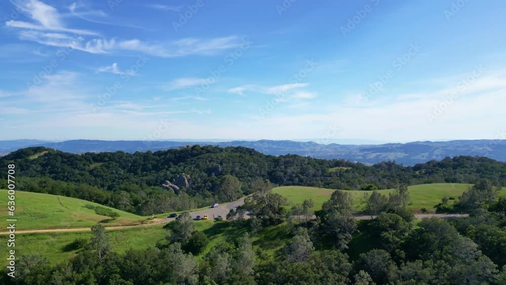 Aerial landscape view of green hills with trees under blue sky on the horizon Aerial landscape view of green hills with trees under blue sky on the horizon