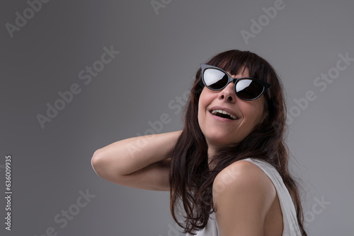 Ordinary lady, sunglasses, feigned cinema diva laugh
