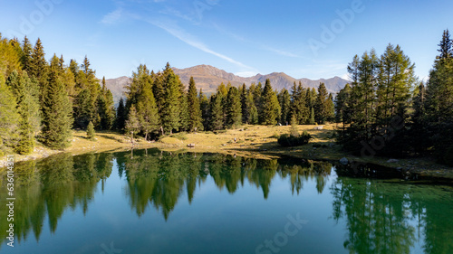 Panorama of the two "Laghi Gelati" in Scaleres on the Dolomites in north Italy at an altitude of 2000 meters in the middle of the forest. View with drone on a summer day with the unique water.