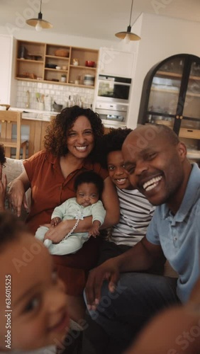 Happy African American family on home sofa waving to camera