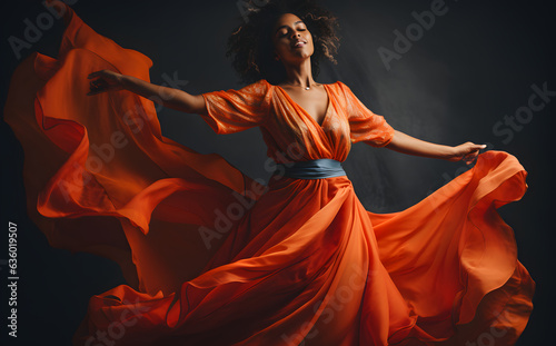 Woman in orange dress studio shot
