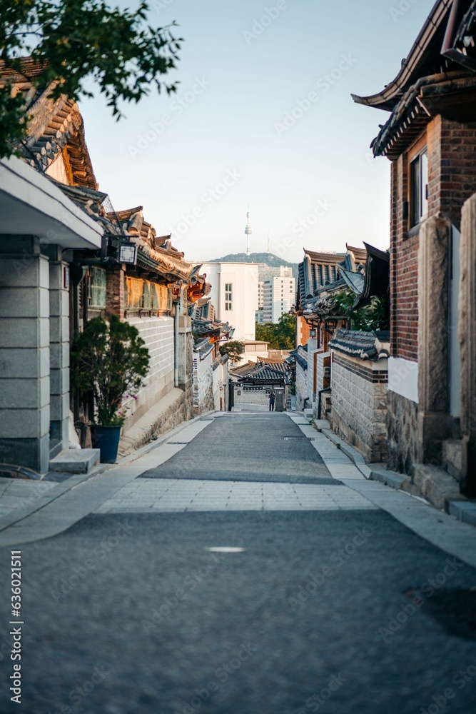 Picturesque view of a narrow road in South Korea, Seoul, at sunset, showcasing the cityscape below