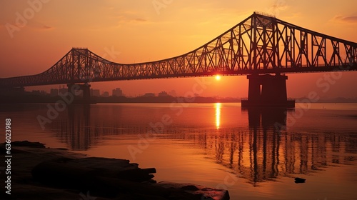 Sunrise silhouette of Howrah Bridge a suspended span over the Hooghly River in West Bengal photo