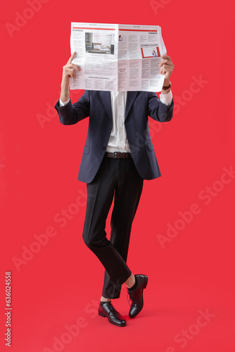 Young man in suit reading n...
