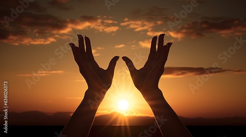 Hands in descent sunsets behind raised female hands. silhouette concept