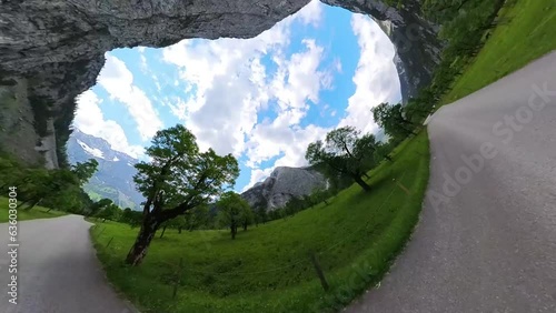 Driving with a motorbike through the Ahornboden in the Karwendel Mountains in the Austrian Alps with a view of the mountains and creatively shifting spheres in panoramic perspective - Video and Audio photo