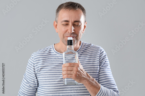 Mature man with bottle of v...