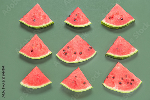 Composition with pieces of ripe watermelon on green background