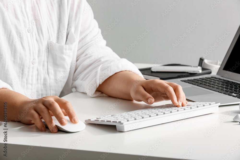 Female programmer typing on computer keyboard at her workplace in office, closeup Female programmer typing on computer keyboard at her workplace in office, closeup