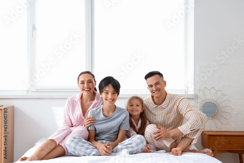 Little children with their parents in bedroom