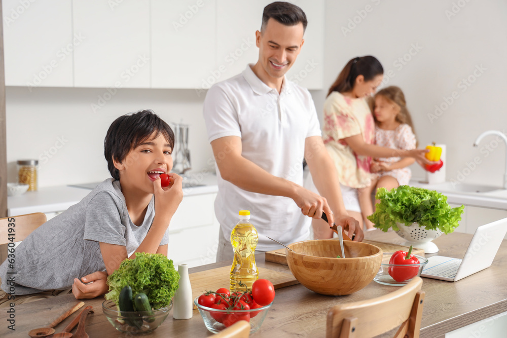 Little boy with his father cooking in kitchen Little boy with his father cooking in kitchen