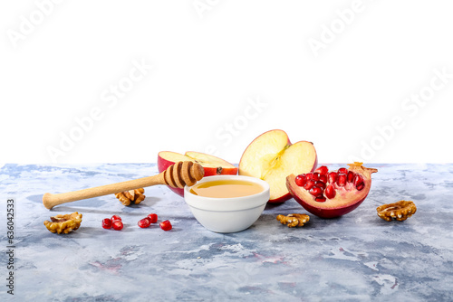 Bowl of sweet honey, fruits and walnuts on color table against white background