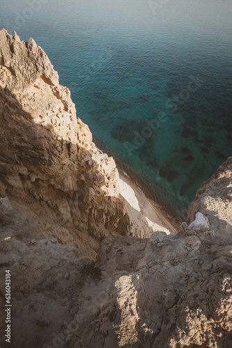 Vertical shot of rocky cliffs over the water near Pissouri trail, Cape Aspro, Pissouri, Cyprus