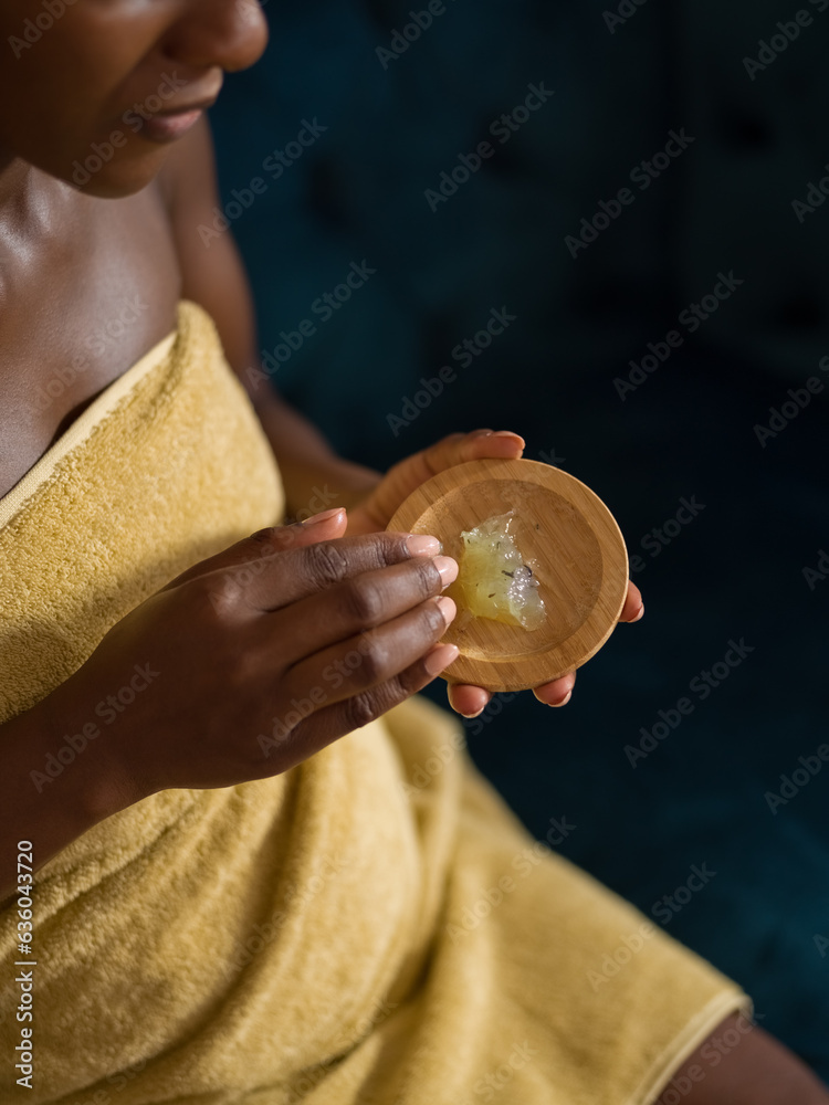 Black woman taking styling gel before applying Black woman taking styling gel before applying