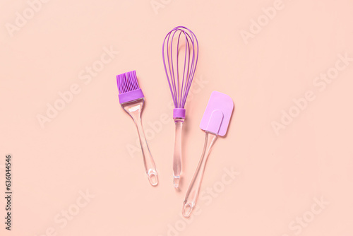 Pastry brush  whisk and spatula on pink background