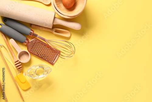 Wooden baking utensils on yellow background