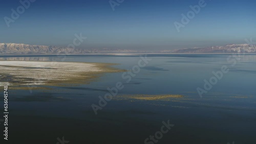 Aerial flyover view of receding water in Great Salt Lake / Magna, Utah, United States