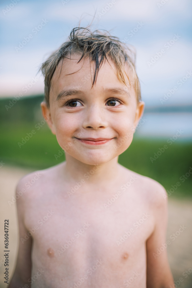 portrait of smiling boy at the lake portrait of smiling boy at the lake