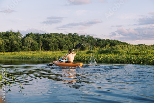 father and son kayaking together on summer day in massachusetts photo