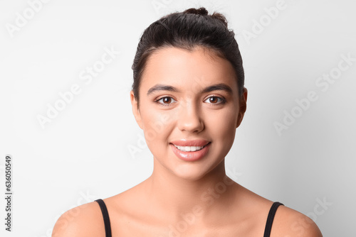 Young woman with beautiful lips on light background  closeup