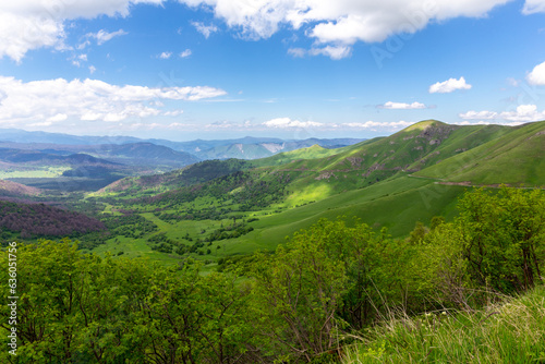 Landscape of Trialeti  Caucasus  mountain range seen from M-20 road to Tskhratskaro Pass  lush green mountains and grasslands  Bakuriani ski resort in summer  Georgia.