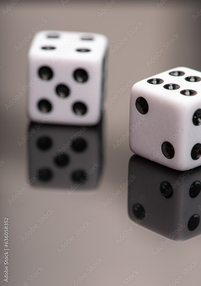 Dice, classic dice resting on reflective surface, selective focus. Dice, classic dice resting on reflective surface, selective focus.