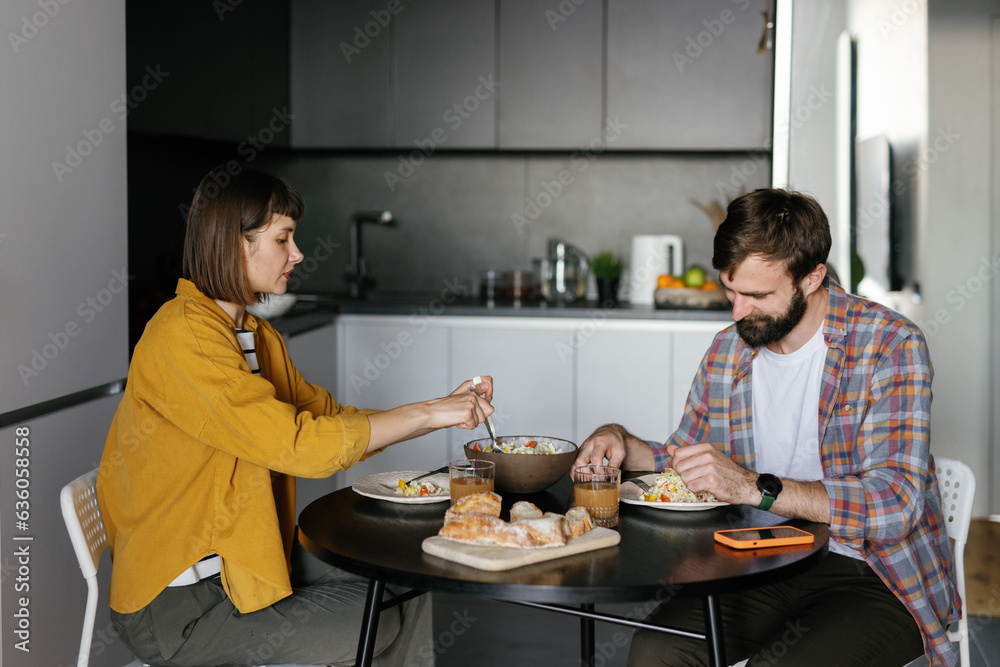 Couple eat food home apartment kitchen Couple eat food home apartment kitchen