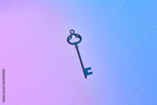 Retro key on neon gradient background.