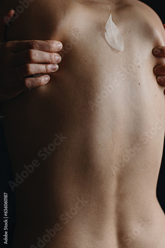 Woman's back skin texture with hands on her shoulder blades