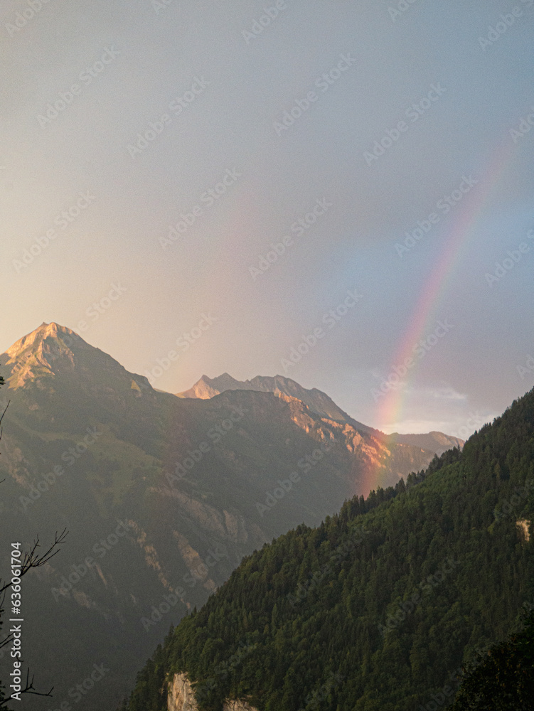 Rainbow at the Mountains during sunset in switzerland top of europe