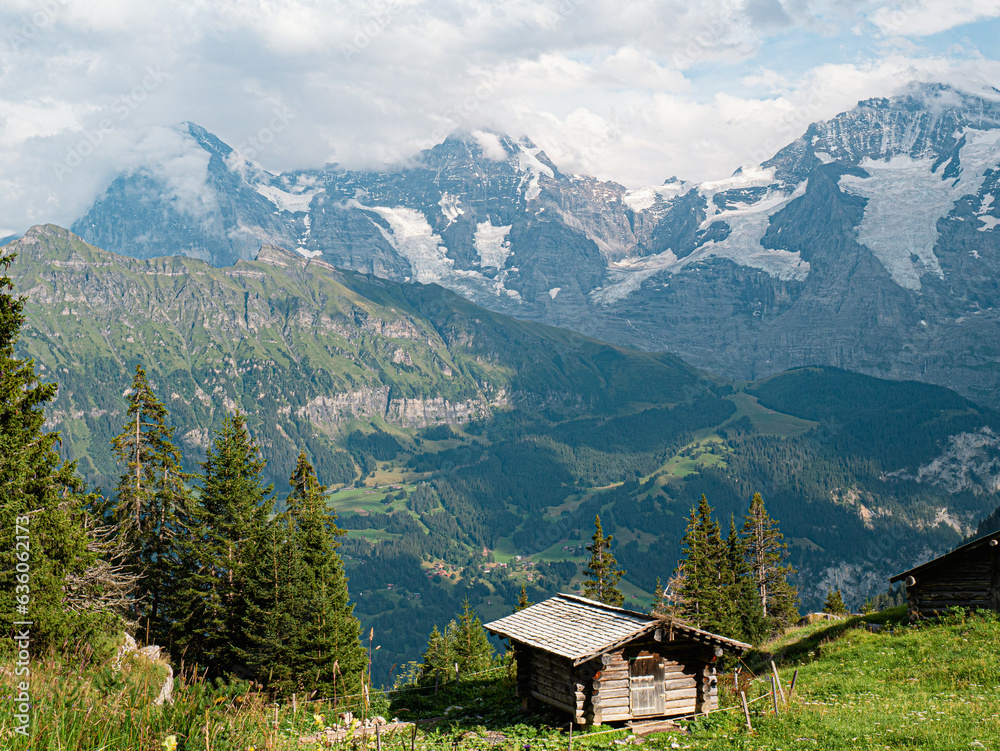Wood cabin with a beautiful view at the Eiger North Face in switzerland berner oberland  with massive glaciers and a wooden cabin