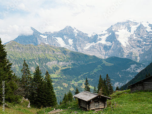 Small alpine wooden cabin in Berner Oberland Jungfrauregion, with Eiger Mönch and Jungfrau in the back in switzerland photo