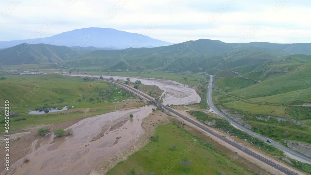 Aerial Shot Of Railway Bridge Over River Near Road, Drone Descending Forward Over Landscape Against Cloudy Sky - Bakersfield, California Aerial Shot Of Railway Bridge Over River Near Road, Drone Descending Forward Over Landscape Against Cloudy Sky - Bakersfield, California