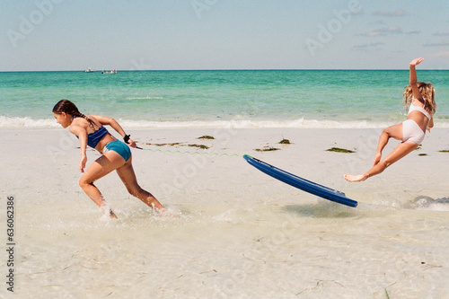 Girl falling off boogie board photo