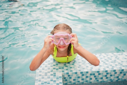 Cute blonde girl with pink goggles photo