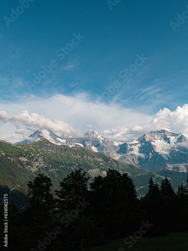 Eiger Mönch and Jungfrau Swiss Alps Berner Oberland Mountains Glaciers Cloudy Mountains North Face Alpine Top of Europe photo