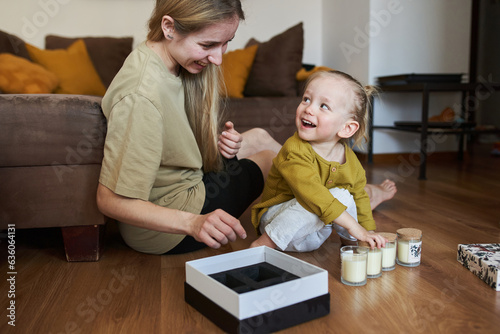 Boy and his mom are looking at candles photo