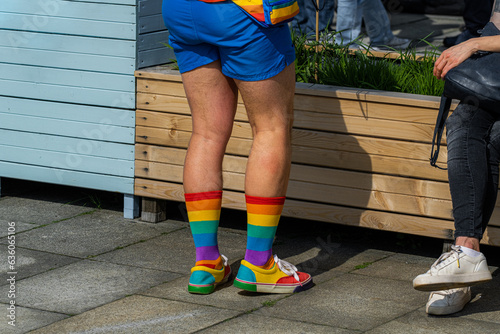 A person with shocking rainbow clothes and bright socks photo