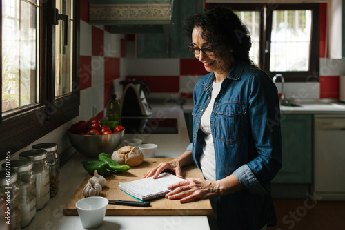 Woman with recipe notes in the kitchen