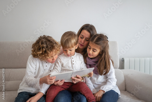 mother reading a story to her children at home