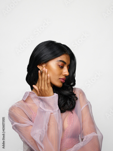Delicate woman with dewy skin and shiny earrings