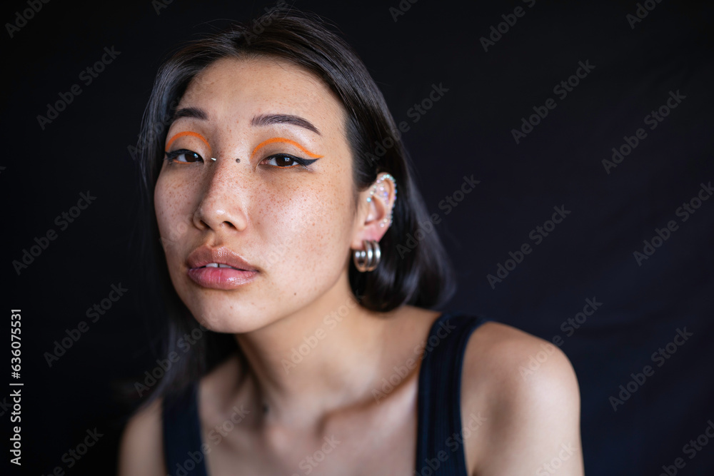 Young woman with makeup and ear piercing Young woman with makeup and ear piercing