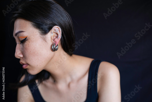 Young woman with makeup and ear piercing photo