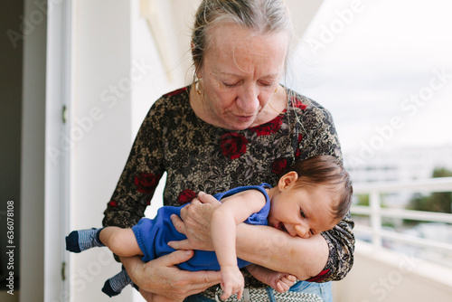 Grandma holding newborn in terrace photo