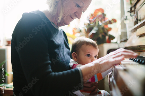 Grandma and baby grandchild playing piano
