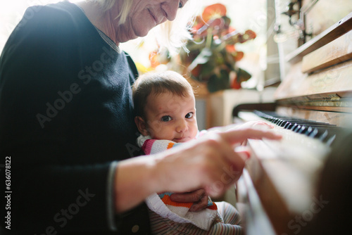 Grandma and baby grandchild playing piano